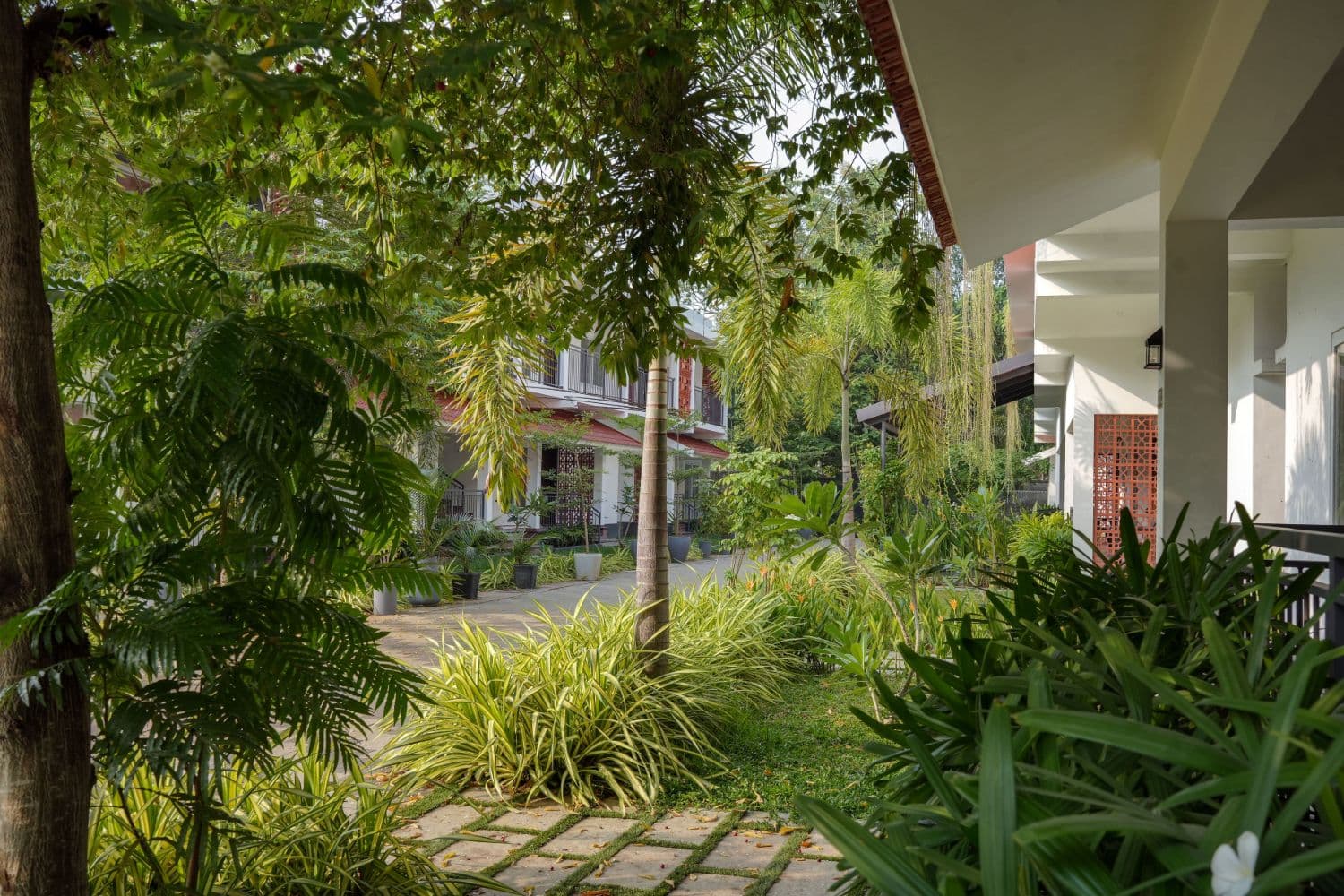 Landscaped garden pathway between villa blocks